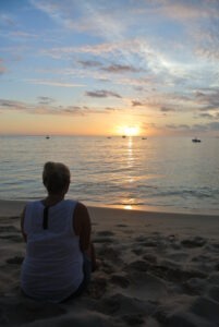 Christina Wyatt sitting on the beach in Fiji